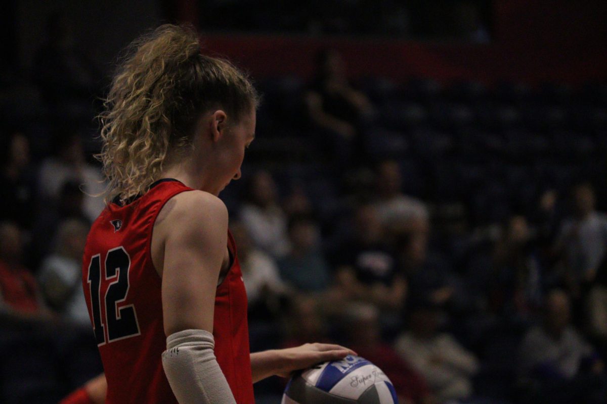 Keira Moore, senior libero/defensive specialist, prepares to serve for the final time at home as a Screaming Eagle during the game against Lindenwood University, Friday, Nov. 14, in Liberty Arena. (Photo by Anderson Schmidt)