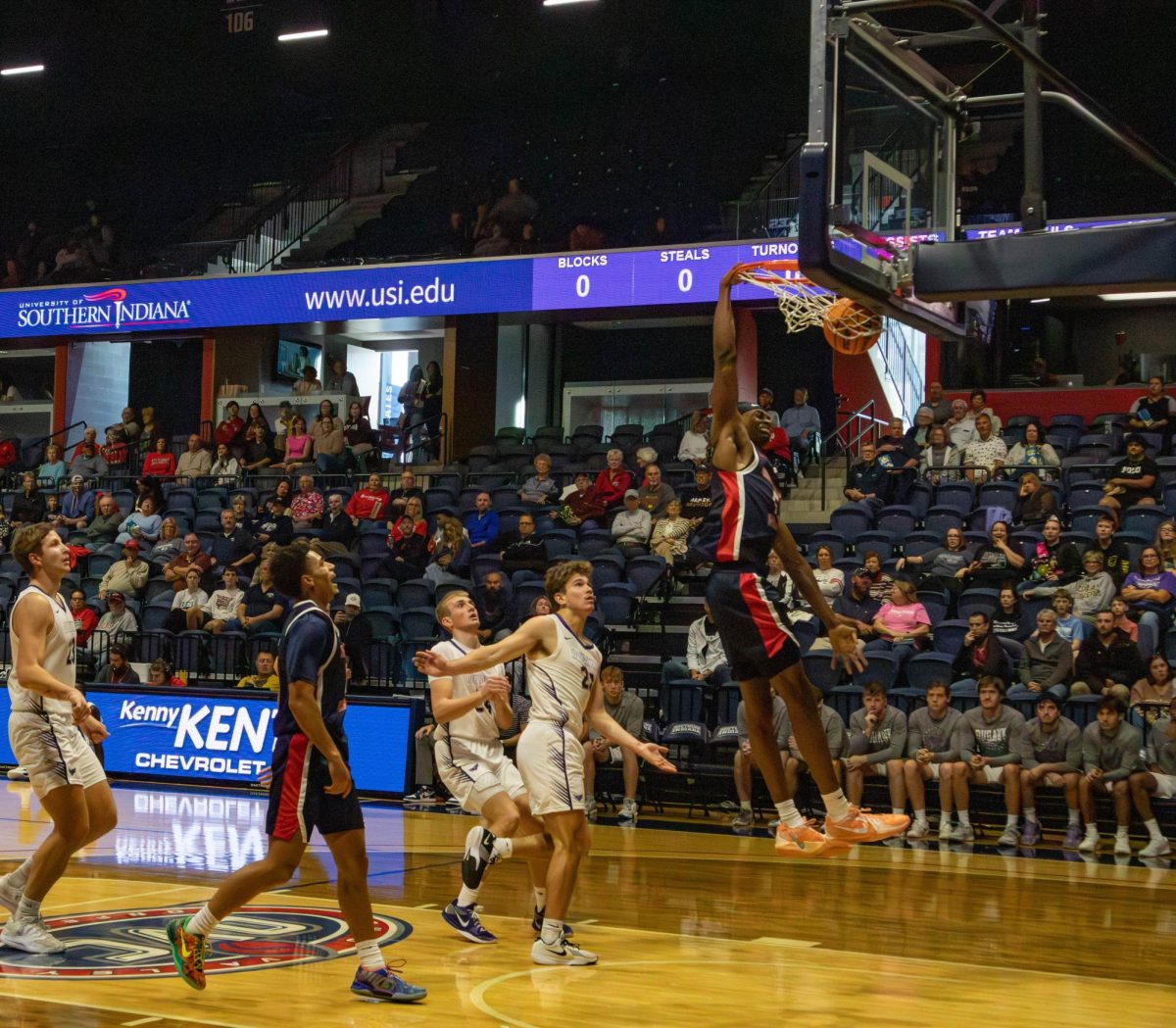 Ola Ajiboye, senior forward, dunks the ball during the first half of the game against Loras College Sunday, Nov. 16, in Liberty Arena. (Photo by Amber Adams)