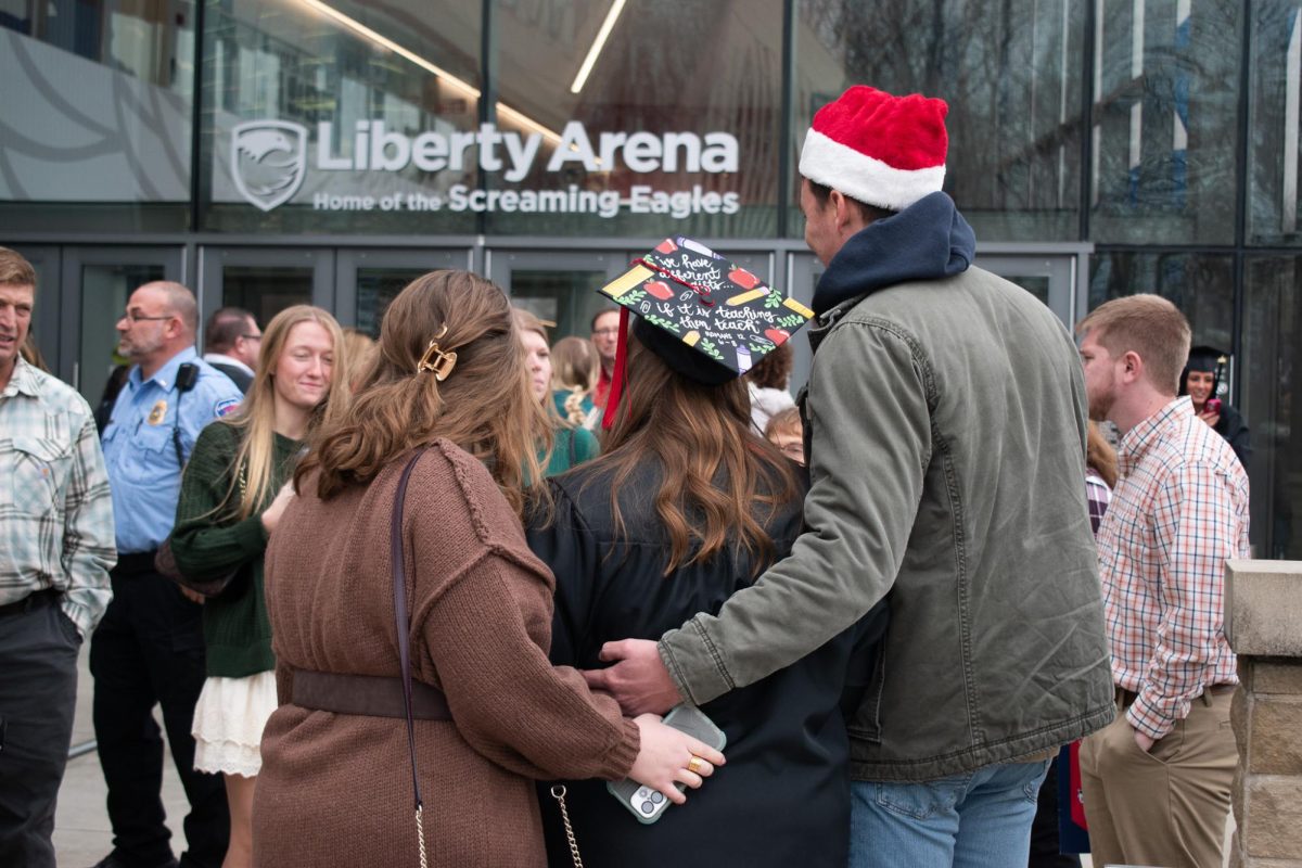 Loved ones take photos with their graduate after the commencement ceremony for the School of Graduate Studies, Kinney College of Nursing and Health Professions and the Pott College of Science, Engineering, and Education, Saturday, Dec. 13, in front of the Liberty Arena.