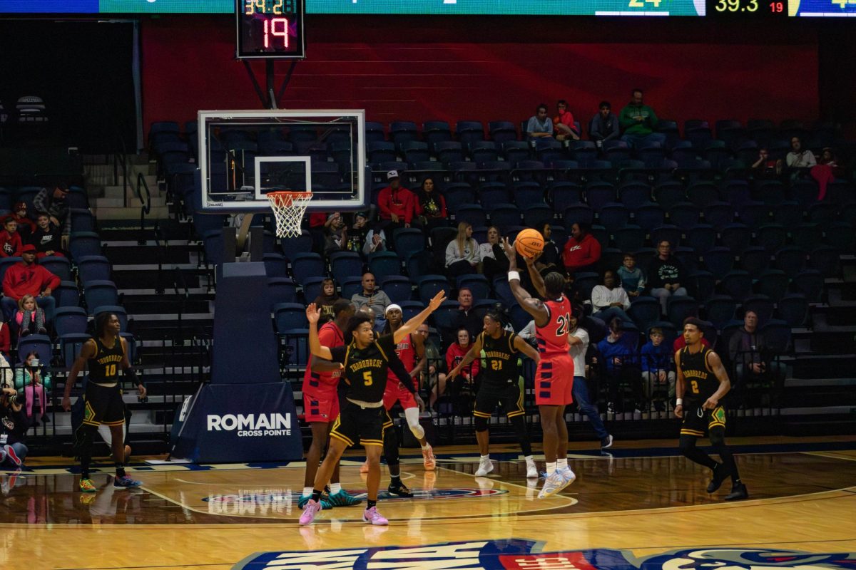 Ismail Habib, senior guard, shoots a three-pointer in the game against Kentucky State University Saturday, Nov. 29, in Liberty Arena.