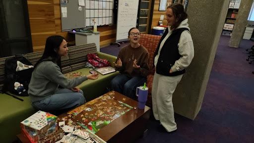 Natalie Tran, sophomore pre-dental hygiene major, Mallory Friend, sophomore political science and sociology major, and Alyssa Tisserand, sophomore diagnostic medical sonography major, work on a puzzle together while talking about what questions they dread around the holidays. 