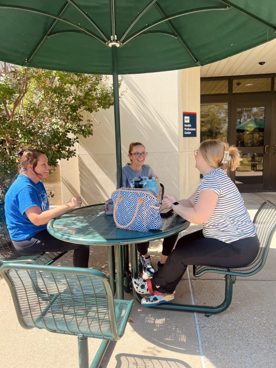 [FILE]: Nursing students sit outside of the Nursing and Health Professions building before renovations Sept. 17, 2024. (Photo by Cade Smithson)