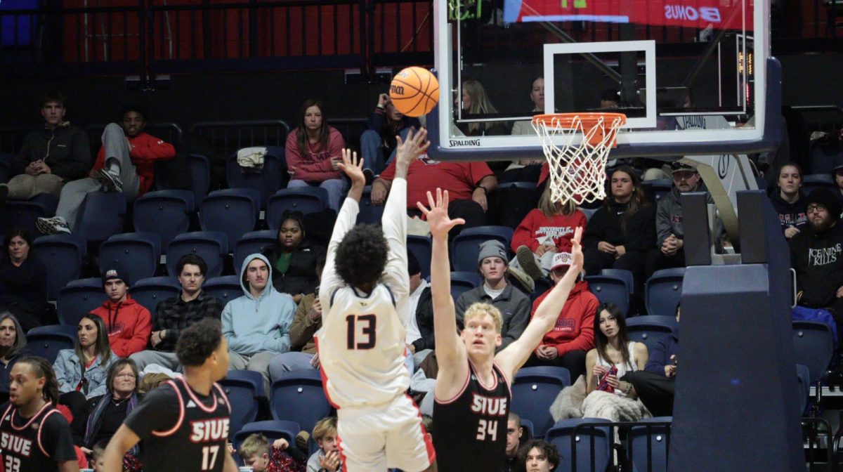 Devin Curtis, junior forward, shoots a heavily contested jump shot over a Southern Illinois University Edwardsville defender Saturday, Jan. 31, at Liberty Arena. (Photo by Anderson Schmidt)