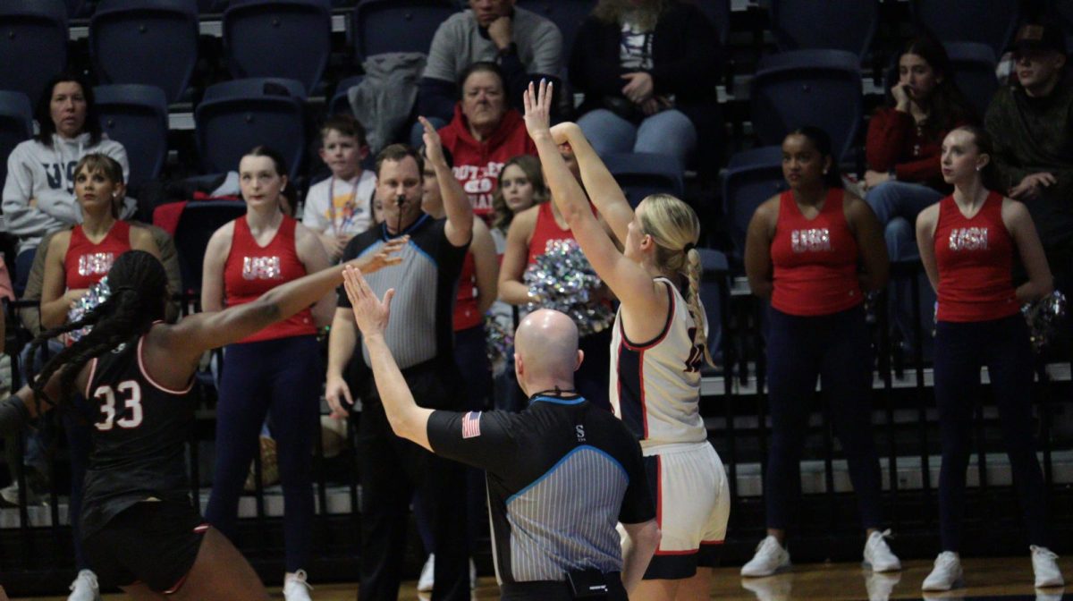 Shannon Blacher, junior guard, shoots a three-pointer in front of a Southern Illinois University Edwardsville defender Saturday, Jan. 31, at Liberty Arena. (Photo by Anderson Schmidt)
