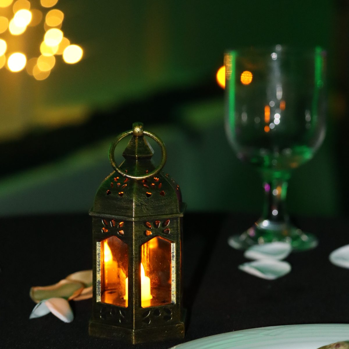 An enchanted forest-themed lantern sits next to a glass cup on a table at the Griffith Center during the homecoming ball Friday, Jan. 30. (Photo by Cade Smithson)