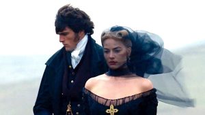 Heathcliff (Jacob Elordi) and Cathy Earnshaw (Margot Robbie) stand close to each other in “Wuthering Heights” (2026).