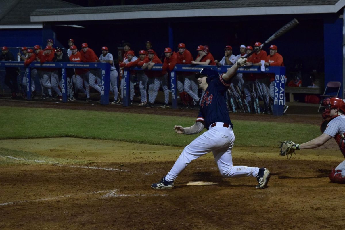 Jesse Velders, graduate student outfielder, hits a ball into the outfield during the game against Illinois State University Tuesday, March 3, at USI Baseball Field. (Photo by Anderson Schmidt) 
