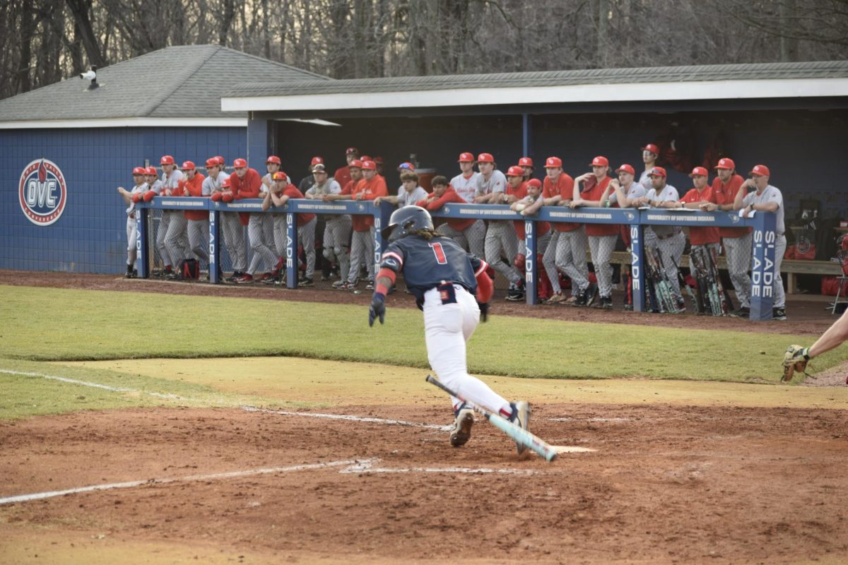 Khi Holiday, graduate student outfielder, runs toward first base after putting the ball into play against Illinois State University Tuesday, March 3, at USI Baseball Field. (Photo by Anderson Schmidt)