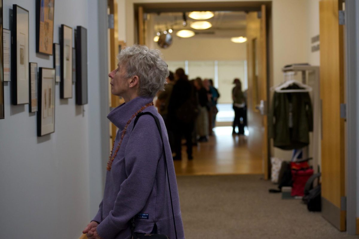 Attendees study “Block & Brush: The Artistry of Japanese Prints and Scrolls” during the opening reception for “Magic Realism: New Works by Michael Aakhus” and “Block & Brush: The Artistry of Japanese Prints and Scrolls,” Wednesday, March 4, in the entrance of the Kenneth P. McCutchan Art Center/Palmina F. and Stephen S. Pace Galleries