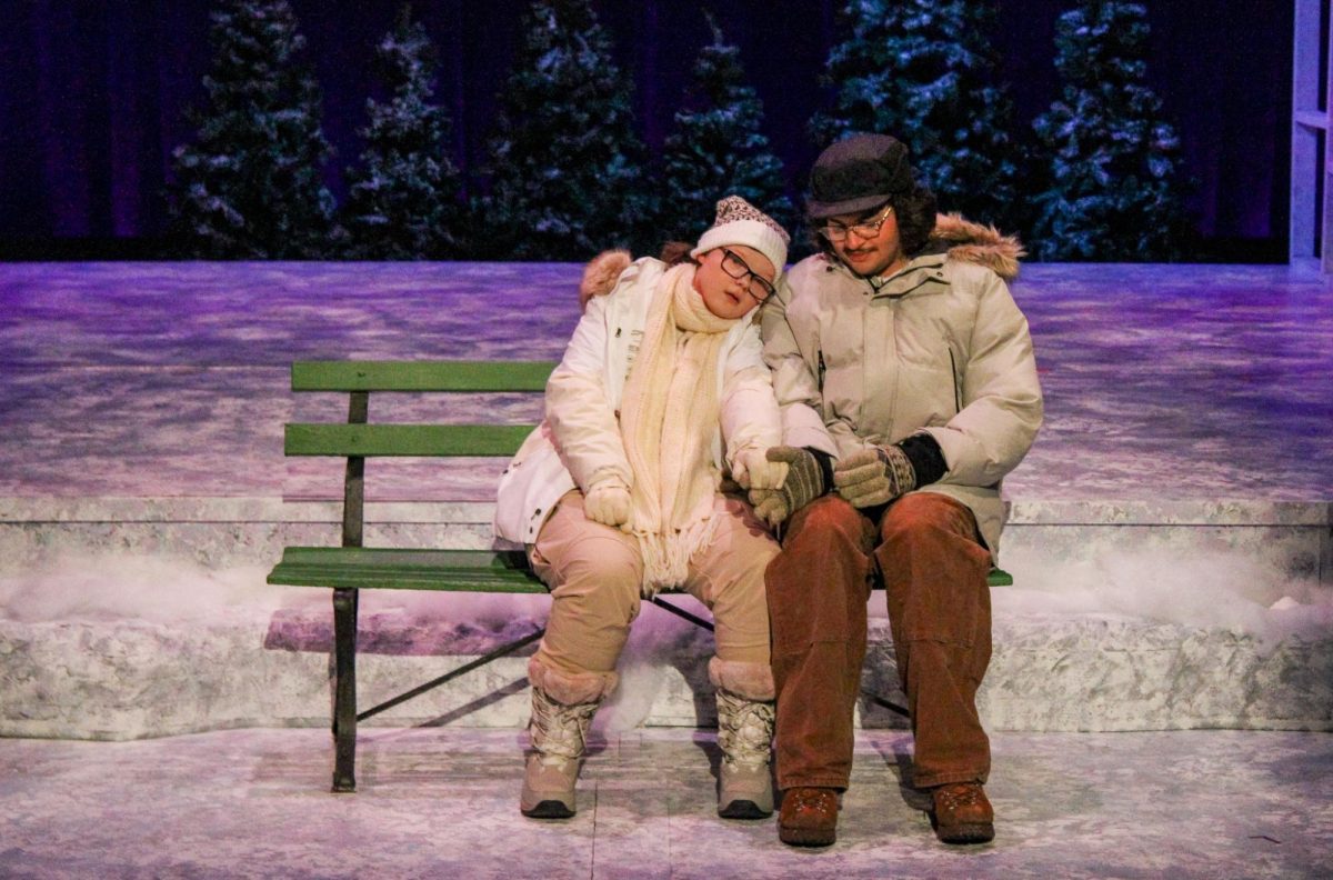 Ginette (Meredith Spooner) and Pete (Qais Jawabreh) hold hands on a bench at a rehearsal of “Almost, Maine” Wednesday, Feb. 18 in the Performance Center.