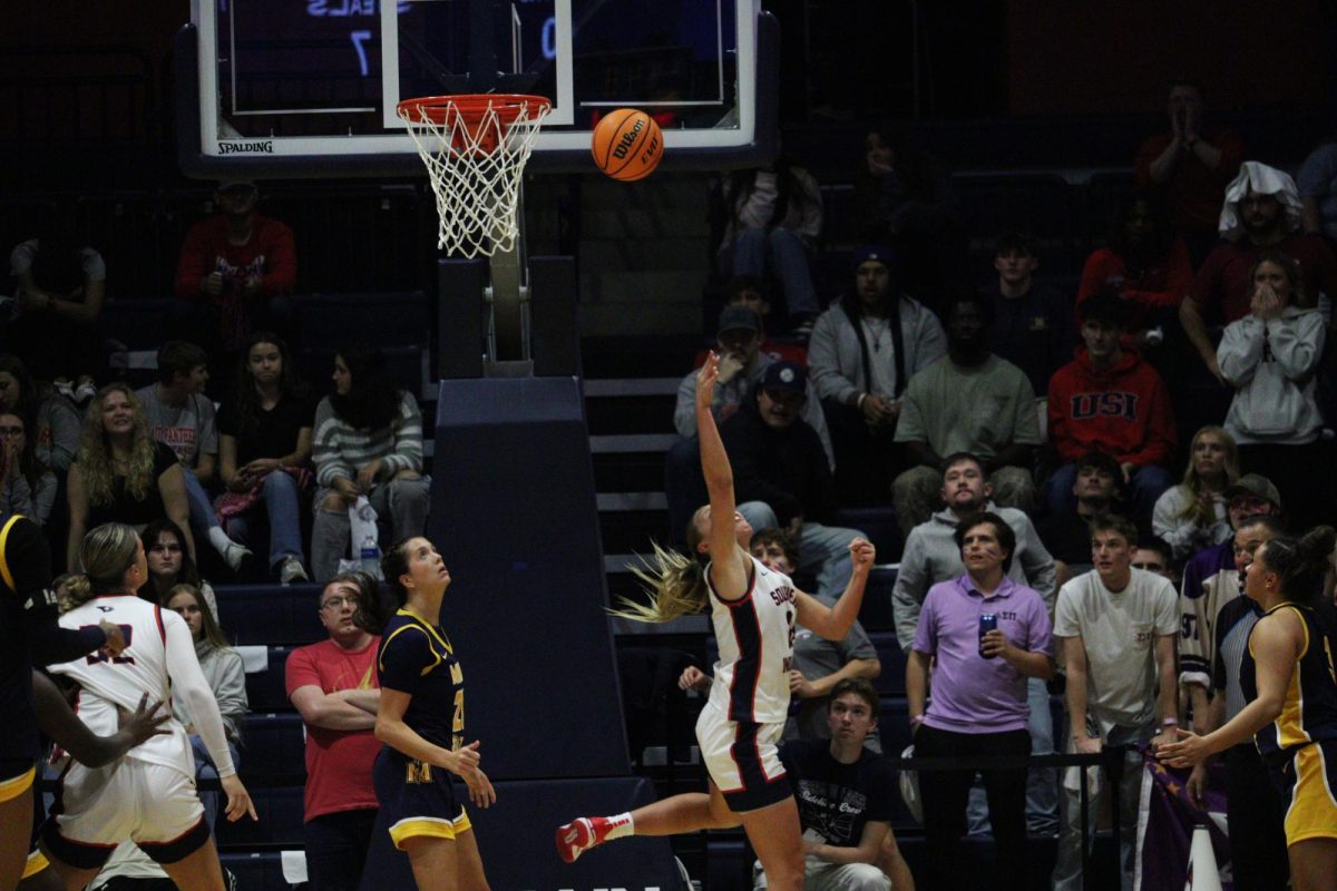 Ali Saunders, senior guard, scores an acrobatic layup during a non-conference matchup this season against Murray State University Friday, Nov. 7, 2025 in Liberty Arena. (Photo by Anderson Schmidt)