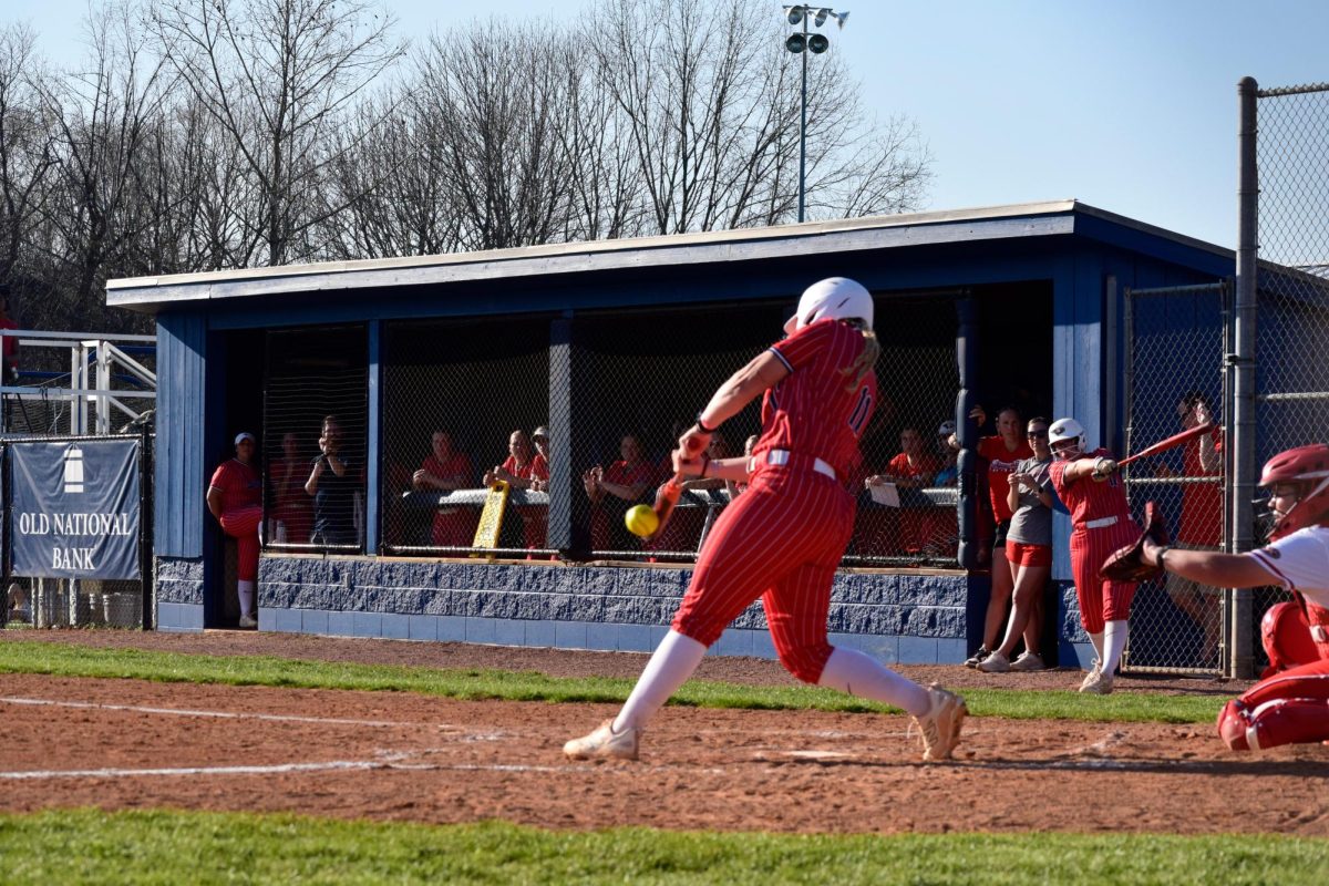 Jadyn Tinsley, freshman infielder, makes contact on a pitch from Southeast Missouri State University Saturday, March 21 at USI Softball Field. (Photo by Anderson Schmidt)