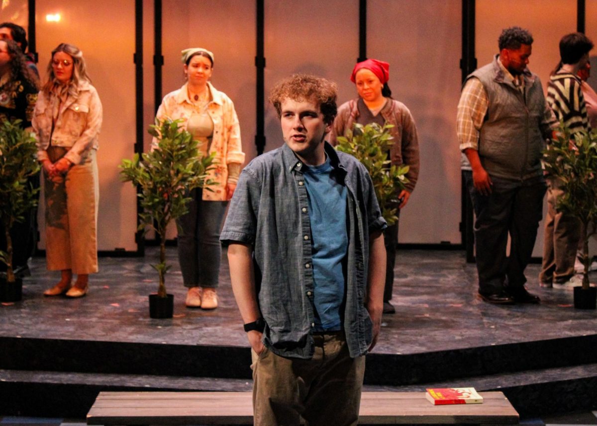 Evan Hansen (Ethan Hoover) stands in the apple orchard with the cast of “Dear Evan Hansen” behind him during a rehearsal of the show at the USI Performance Center Wednesday, April 22. (Photo by Izzy Hannon)