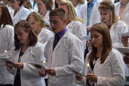 Chris Berry, Nursing, Junior recites the nursing pledge along side his peers during the White Coat Ceremony Friday in the Mitchell Auditorium. This was the first year for the White  Coat Ceremony at the University of Southern Indiana.