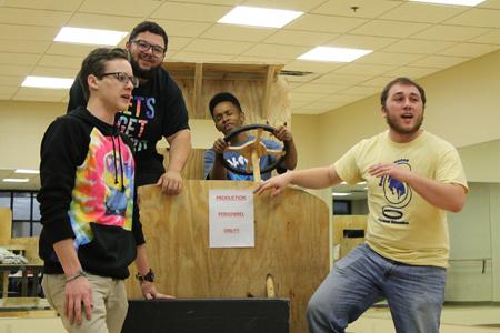 Freshman theater arts major Collin Culliver, sings along with senior theatre arts major AJ Mason, freshman theatre arts major DAngelo Himes, and junior theatre arts major Drew Duvall as they rehearse for a scene in the Grapes of Wrath which runs Oct. 15-18 in the Performance Center.