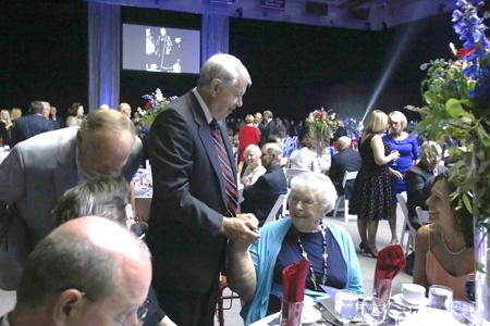 Former President Ray Hoops greets Betty Rice, wife of the first President David Rice, as he arrives at the Party of the Decades. The Party of the Decades was a 50th anniversary celebration that took place in the PAC Saturday.