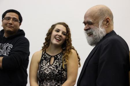 USI students senior Julio Canseco-Ramos and junior Sarah Sadowski share a

laugh as they introduce themselves to guest speaker Victor Villanueva.