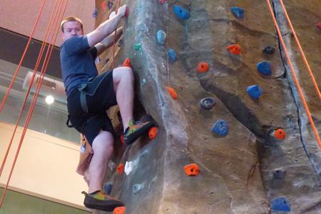  Brandon Becker, a junior majoring in geology, climbs the rock wall in the RFWC. 
