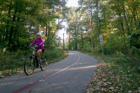 A bicyclist takes on the USI-Burdette Trail Monday afternoon. This three-mile paved path will be honored at Celebrate the Trail on Saturday.