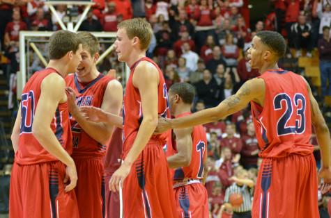 Eagles celebrate during their opening exhibition contest at Indiana University in October. PHOTO by JIMMY PYLES