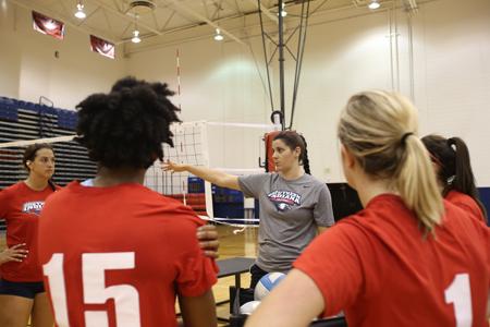 Elisa Joris, the new women’s volleyball team Assistant Coach, explains the next drill during a break in practice Monday. 