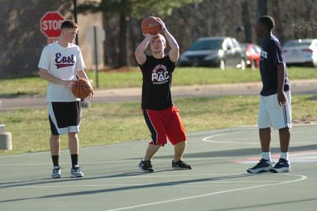 Sophomore engineering major Ian Mathis and sophomore elementary education major Nicholas Herron play basketball outside of the C-store with a friends brother, Corey Kirkland, 13. Both students live in the Marshall apartment complex on campus.