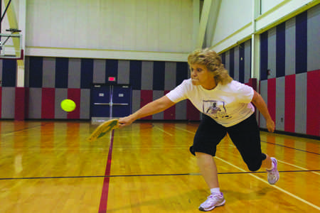 Sherry Tynes, the Information Systems Associate in the USI Foundation office, returns a serve during a game of Pickle Ball during their weekly faculty game.