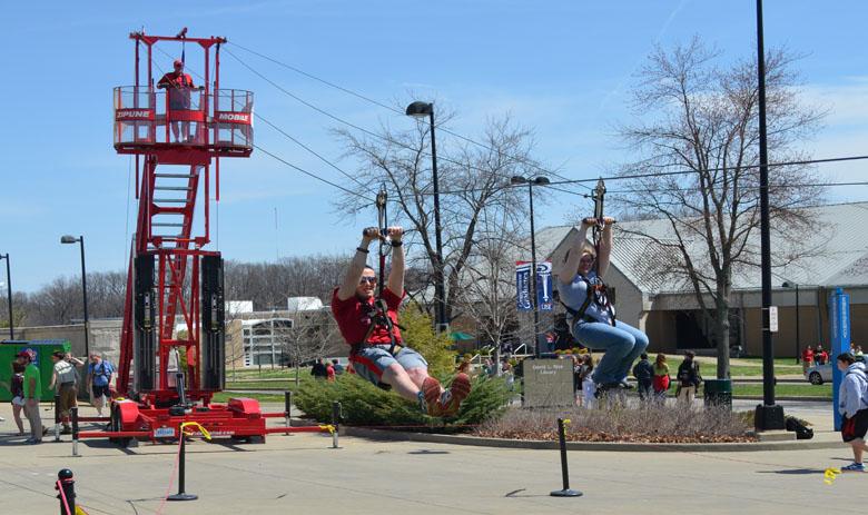 Students glide through the air on a zip line during USIs SpringFest festivities in 2014.