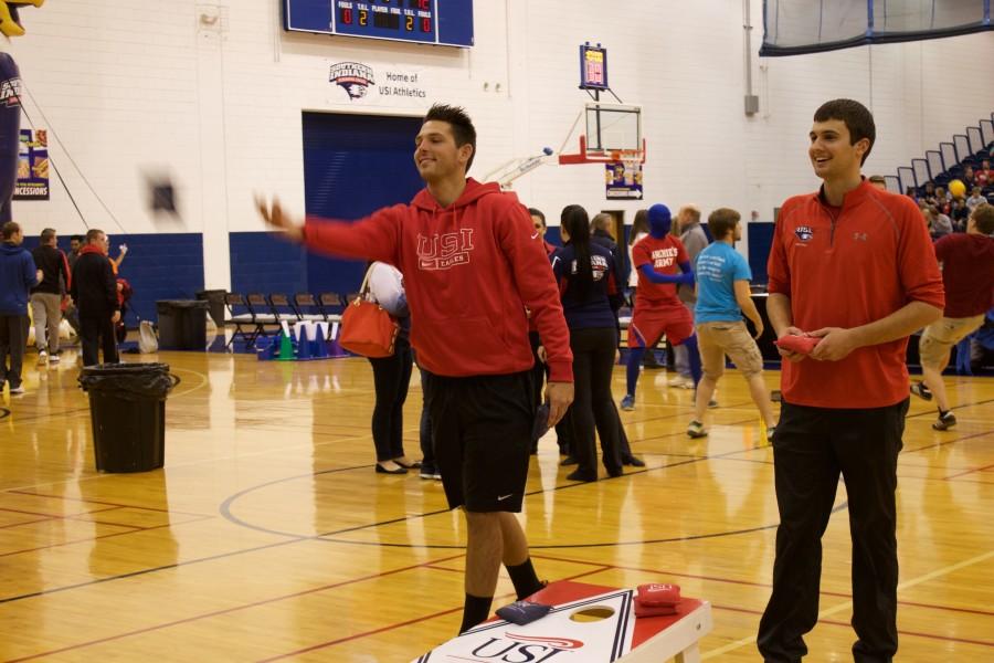 PAC supervisor, Justin Ahlbrand, (right) plays corn hole with USI alum Jeff Neidlinger (left) during midnight madness on Friday. Ahlbrand is one of eight students in the sport management graduate program.